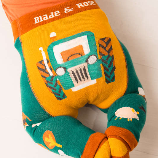 Colorful children's neck pillow with tractor design and 'Blade & Rose' branding.